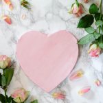 pink heart shaped paper on white and pink floral textile